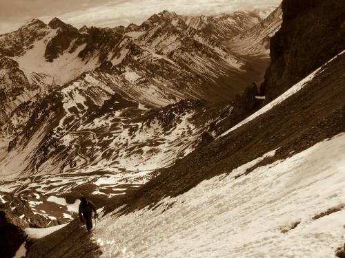 a man walking down a snow covered mountain at Portezuelo del Viento - Hostel de Montaña in Las Cuevas