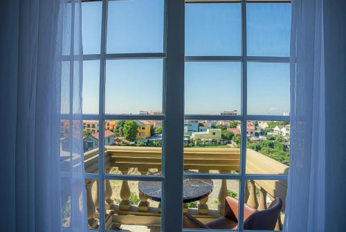 a window with a view of a city at Premium CGP Hotel Hoi An in Hoi An