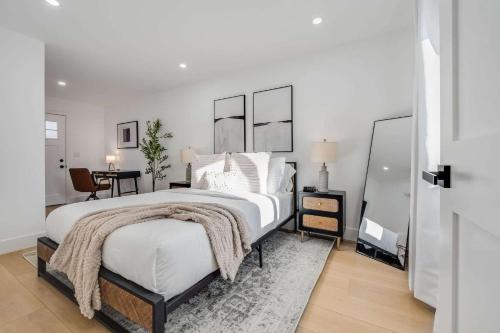 a bedroom with a large white bed with a rug at Brand New Apt W Parking Blocks From Downtown- B in Sunnyvale
