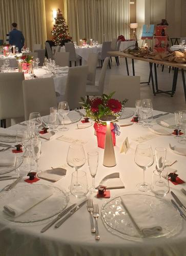 a table with white plates and silverware on it at Il Castagneto Hotel in Melfi