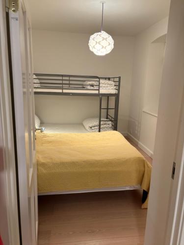a small room with a bunk bed and a light at Guest house on farm in small village in Næstved