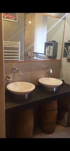 une salle de bain avec deux lavabos et un miroir dans l'établissement chalet LES GRANDES TERRES, à Enchastrayes