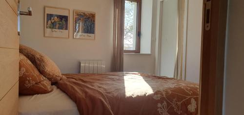 a bedroom with a bed with a blanket on it at Château les Poules in Assignan