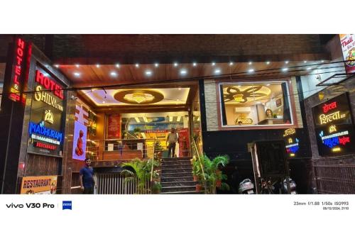 a man is standing outside of a restaurant at Hotel Shilva Inn in Varanasi