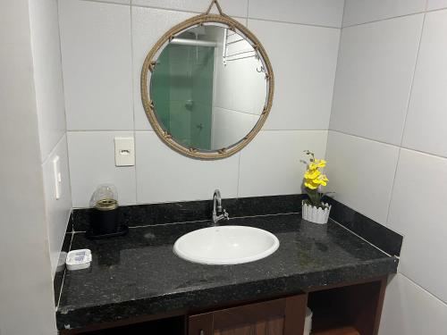 a bathroom with a sink and a mirror at Pousada Solar Maia Costa in Atins