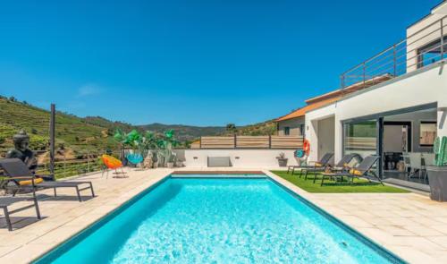 a swimming pool in the backyard of a house at Valadouro Amazing Villa in Douro Valley - Pool in Espinhosa