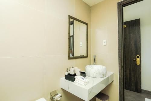 a bathroom with a sink and a mirror at Premium CGP Hotel Hoi An in Hoi An