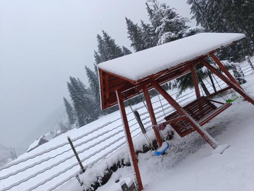 a gazebo with snow on top of it at Casa de Piatră - Colț de Rai in Arieşeni