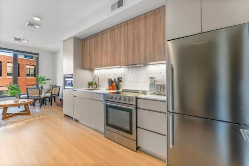 a kitchen with a stainless steel refrigerator and a table at Furnished Apartment in South Boston in Boston