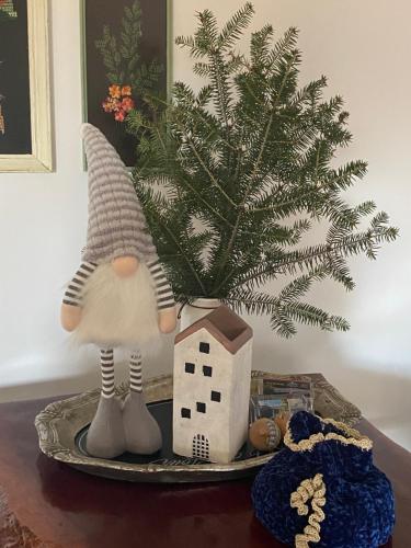 a table with a christmas tree and a toy house at Lavender farm house in Nafpaktos