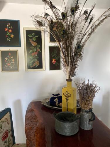 a table with a vase with flowers in it at Lavender farm house in Nafpaktos