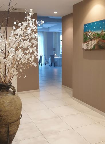 a lobby with a vase with flowers in it at Il Castagneto Hotel in Melfi
