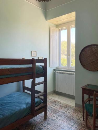 a room with two bunk beds and a window at Villa Pietralunga in the woods in Nicosia