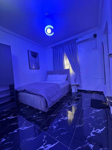 a bedroom with a bed with a blue ceiling at The Apartment at Akoka Yaba, Lagos - House 16 Shobande Street in Yaba