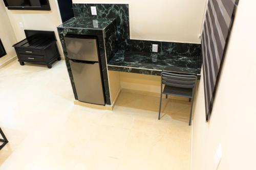 a kitchen with a counter and a table and chairs at Hotel Socram GH in Cabo San Lucas