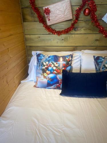 a white bed with christmas decorations on it at Crabmill glamping bewdley in Bewdley