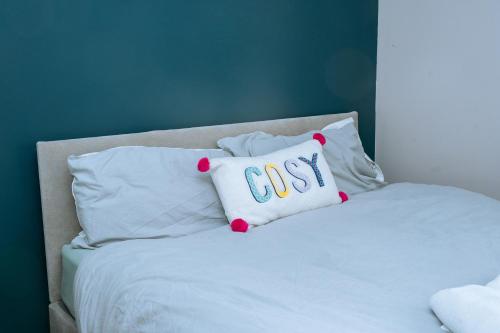 a white bed with a pillow with the word only at Modern 3Bed Home close to Leeds City Centre in Killingbeck