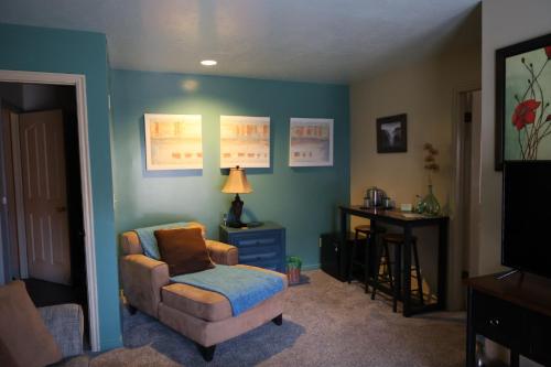 a living room with a chair and a table at Harvest House Bed and Breakfast in Springdale