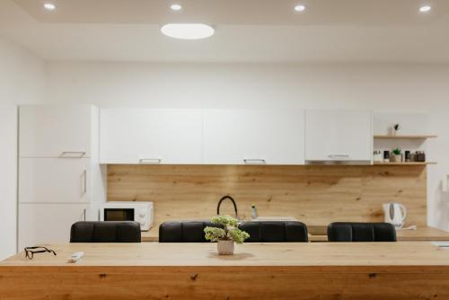 a large wooden table in a room with chairs at Apartmani MODUS - SELF-CHECK-IN in Virovitica