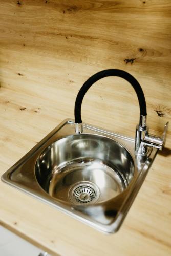 a stainless steel sink in a wooden counter top at Apartmani MODUS - SELF-CHECK-IN in Virovitica
