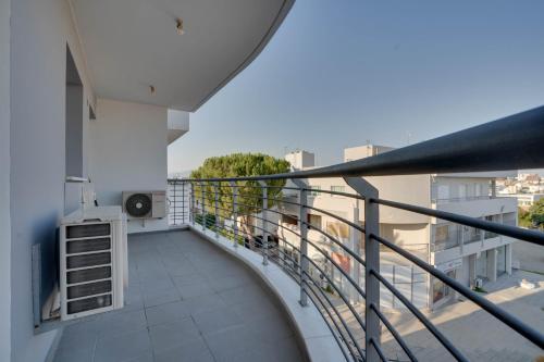 an apartment balcony with a view of a city at Spacious Modern 3bd Apt In Prestigious Engomi in Ayios Dhometios