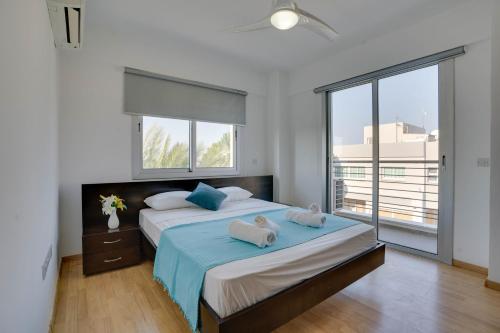 a bedroom with a large bed with two pillows on it at Spacious Modern 3bd Apt In Prestigious Engomi in Ayios Dhometios