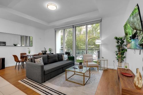 a living room with a couch and a table at 1BR Near BOK Center-Gym, Lounge, Balcony, Pets OK in Tulsa
