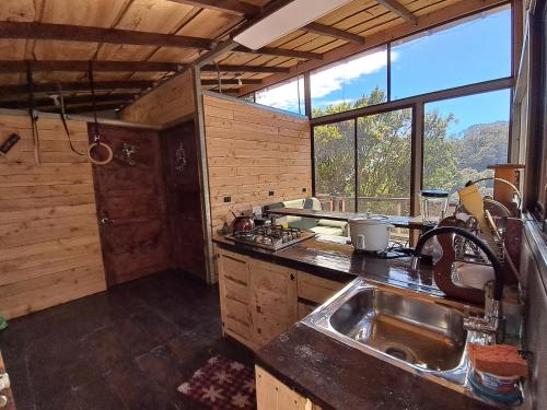 a kitchen with a sink and a large window at Altura House in Rivas