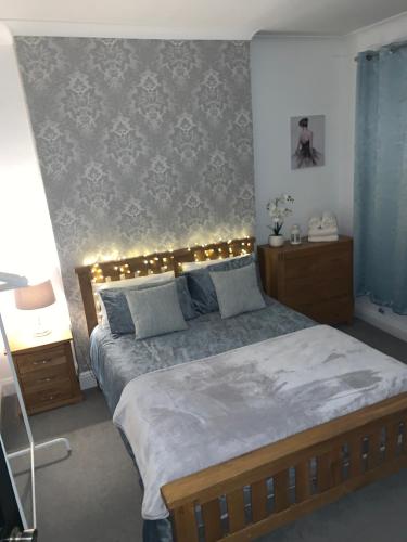 a bedroom with a large bed with lights on it at Stylish 91sqm Victoria 2 bedroom Apartment in Bristol