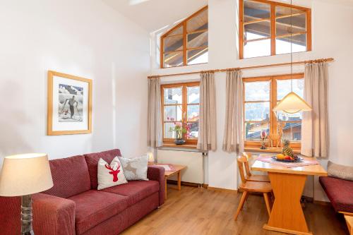 a living room with a couch and a table at Gästehaus Hanna Teifel in Reit im Winkl