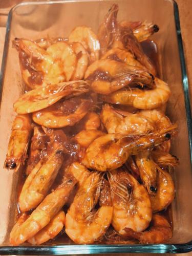 a glass tray filled with shrimp in a sauce at Villa Shakira in Zissersdorf