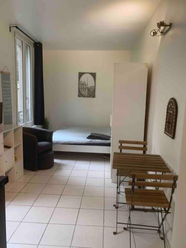 un salon avec un lit et un canapé dans l'établissement Entire Studio - Arena La Chapelle, à Paris