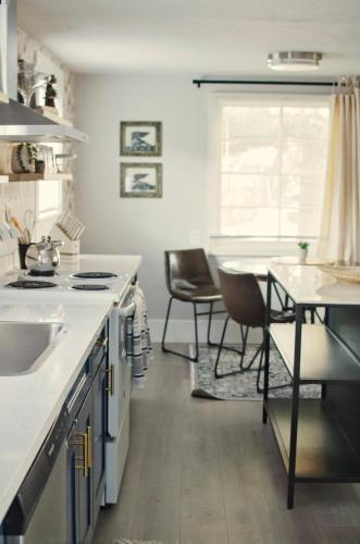 a kitchen with a sink and a table with chairs at NEW! OSU Campus Stadium Boho Glamour in Corvallis