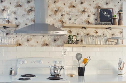 a kitchen with a stove top oven with a counter top at NEW! OSU Campus Stadium Boho Glamour in Corvallis