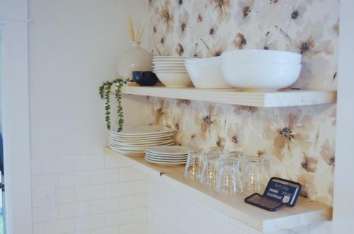 a shelf with plates and bowls and glasses on it at NEW! OSU Campus Stadium Boho Glamour in Corvallis
