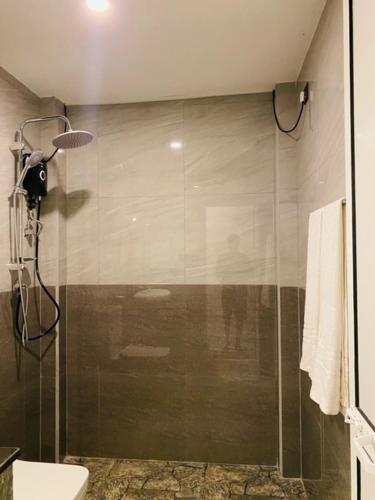 a shower with a glass door in a bathroom at Eco Vibe Villa Hiriketiya in Dickwella