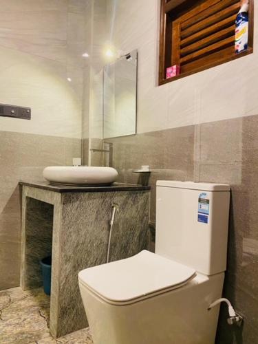 a bathroom with a toilet and a sink at Eco Vibe Villa Hiriketiya in Dickwella