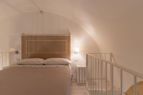 a bedroom with a bed and a stair case at SASSO BIANCO in Matera