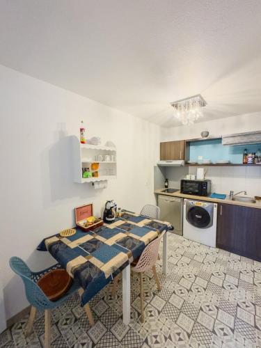 une cuisine avec une table et des chaises dans une pièce dans l'établissement Appartement familial, à 10mn de Disneyland, à Montévrain