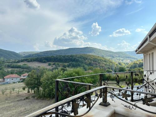 a balcony with a view of the mountains at Villa Ovcharovo in Targovishte