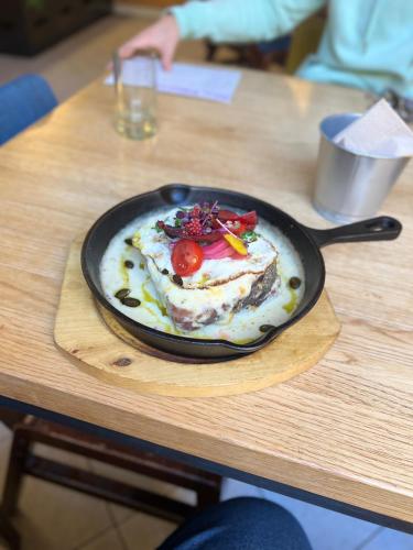 a plate of food in a pan on a table at Nap Hostel Pécs in Pécs