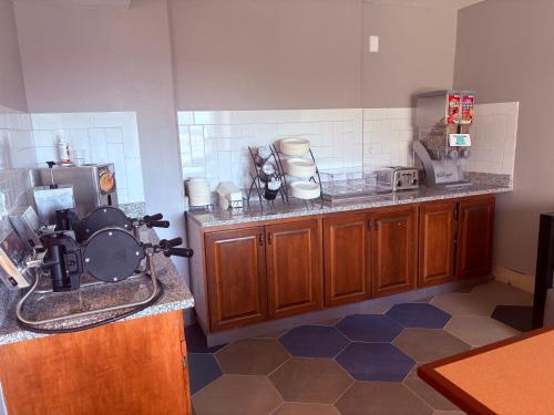a kitchen with a coffee maker on a counter at Microtel Inn & Suites by Wyndham Denver Airport in Denver