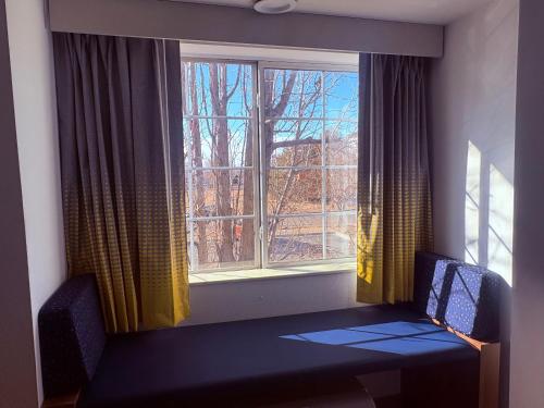 a room with a window with a table and two chairs at Microtel Inn & Suites by Wyndham Denver Airport in Denver