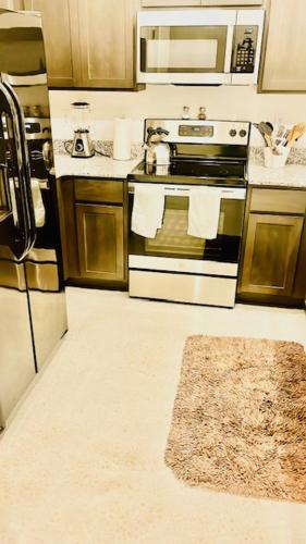 a kitchen with a stove and a microwave at 3 bed 2 bath - Modern Furnished B Side Corporate Stays Home Away - mins from Austin in Copperas Cove