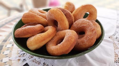 a bowl of donuts sitting on a table at Dar Beynana in Sidi Bibi