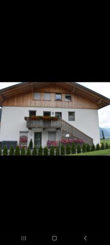 a large white building with a balcony on it at Oberhuberhof in SantʼAnna