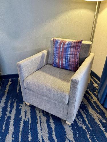 a chair with a pillow in a room at Garner Hotel Longview South by IHG in Longview