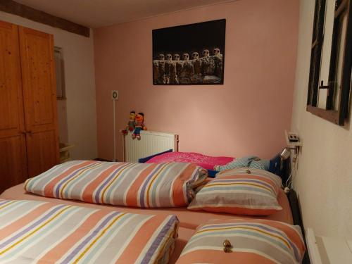 a bedroom with two beds and a painting on the wall at HAUS BRAILEN in Brilon Alme in Brilon