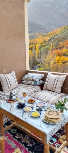 a living room with a table with food on it at Gite Soleil in Tacheddirt