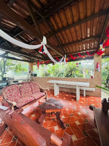a living room with a couch and a table at Cabañas La Hermosa #1 in Guápiles